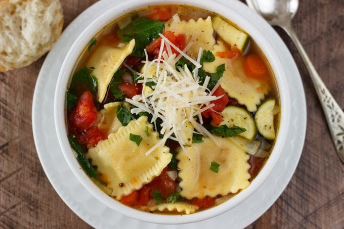 Ravioli Soup- A quick, one pot dinner idea the whole family will love. Healthy fresh vegetable soup gets kicked up a notch with the addition of fresh ravioli. A hearty filling meal that won’t break the bank. | SimpleHealthyKitchen.com