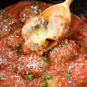 Crockpot Cheesy Meatballs-These Italian inspired meatballs have an ooey gooey cheesy surprise inside! (yes! there is cheese stuffed inside the meatball!)