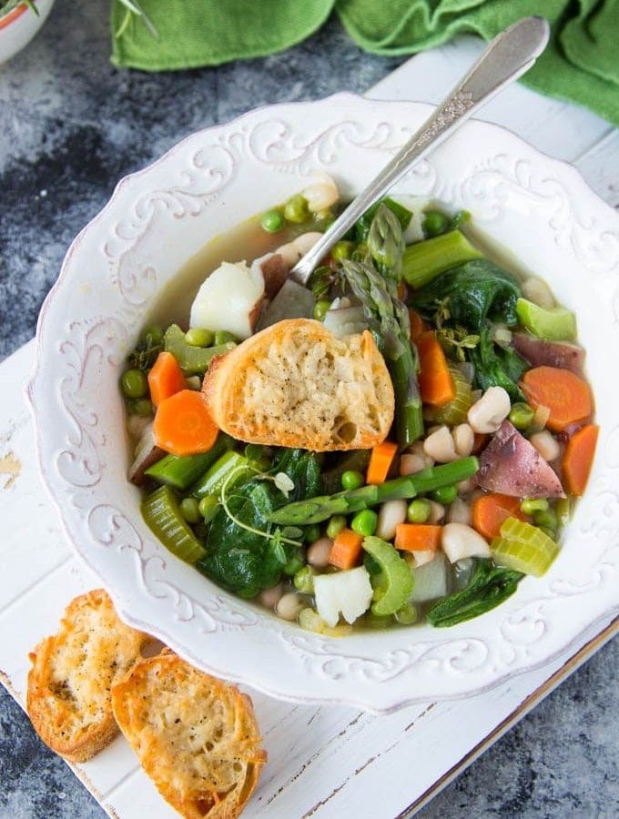 spring vegetable soup in a white bowl