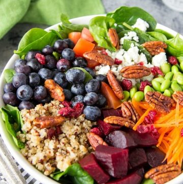 Quinoa + Spinach + Blueberry Superfood Bowl- A big bowl of nutritious goodness! Packed with 9 superfoods (quinoa, spinach, blueberries, carrots, edamame, beets, cranberries, tomatoes and pecans) these bright and colorful bowls not only pack in a lot of healthy nutrition , they are extremely tasty and keep you feeling full thanks to the combination of protein and fiber in these superfoods