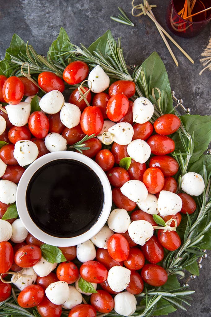 Mozzarella Balls, grape tomatoes arranged in the shape of a Christmas Wreath on a platter