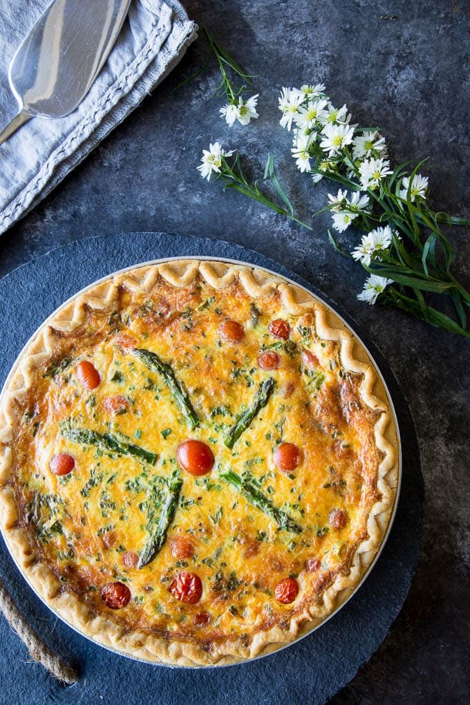 Asparagus, Tomato & Cheddar Quiche- A quick and easy quiche recipe for the “non-baker” or for when you want a fancy and impressive company worthy meal with only about 10 minutes prep time. Perfect for breakfast, brunch, lunch or dinner.