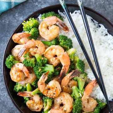 Skillet Honey Garlic Shrimp with broccoli in a black bowl over white rice