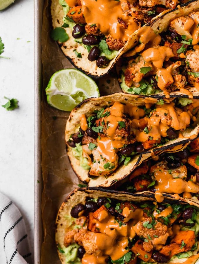 Soft Tacos filled with roasted cauliflower, black beans and cashew crema sauce