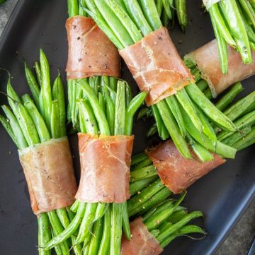 Green Bean Bundles stacked on a black serving tray